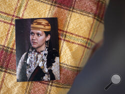 A picture of missing woman Emmilee Risling sits on a table at the Risling family home on Jan. 21, 2022, in McKinleyville, Calif. The 33-year-old college graduate — an accomplished traditional dancer with ancestry from three area tribes — was last seen more than four months ago walking across a bridge near End of Road, a far corner of the Yurok Reservation where the rutted pavement dissolves into thick woods. Her disappearance is one of five instances in the past 18 months where Indigenous women have gone mi