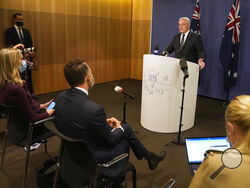 Australian Prime Minister Scott Morrison talks about the situation in Ukraine at a news conference in Sydney, Wednesday, Feb. 23, 2022. Australia has announced additional sanctions on Russia and is warning businesses to prepare for retaliation through Russian cyberattacks. Morrison said Wednesday that targeted financial sanctions and travel bans will be a first batch of measures in response to Russian aggression toward Ukraine. (AP Photo/Rick Rycroft)