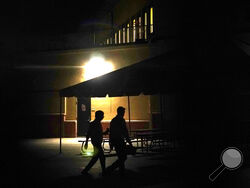 Representatives from Major League Baseball walk to labor negotiations with the players' association, Monday, Feb. 28, 2022, at Roger Dean Stadium in Jupiter, Fla. (AP Photo/Lynne Sladky)