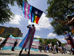 FILE - Demonstrators gather on the steps to the State Capitol to speak against transgender-related legislation bills being considered in the Texas Senate and Texas House, Thursday, May 20, 2021 in Austin, Texas. A Texas judge on Friday, March 11, 2022 blocked the state from investigating as child abuse gender confirming care for transgender youth. District Judge Amy Clark Meachum issued a temporary injunction preventing the state from enforcing Republican Gov. Greg Abbott’s directive to compel the Departmen