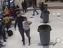 In this frame grab from surveillance video provided by the Kenosha Unified School District, an off-duty police officer escorts a 12-year-old student out of a school cafeteria following a lunchtime fight, in Kenosha, Wis., on March 4, 2022. Earlier in the video, the officer, who was working as a security guard, is shown intervening in the fight and putting his knee on the girl’s neck to restrain her. (Kenosha Unified School District via AP)