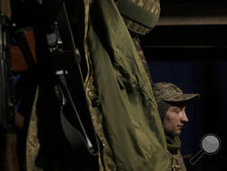 Ukrainian servicemen rest inside a bunker on the outskirts of Kyiv, Ukraine, Sunday, March 20, 2022. Russian forces pushed deeper into Ukraine's besieged and battered port city of Mariupol on Saturday, where heavy fighting shut down a major steel plant and local authorities pleaded for more Western help. (AP Photo/Vadim Ghirda)