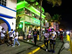 Crowds fill the sidewalks along Ocean Drive during Spring Break in Miami Beach, Florida, on Sunday, March 20, 2022.(Daniel A. Varela/Miami Herald via AP)