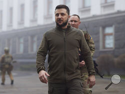 In this photo provided by the Ukrainian Presidential Press Office, Ukrainian President Volodymyr Zelenskyy, center, walks before a meeting with President of the European Parliament Roberta Metsola in Kyiv, Ukraine, Friday, April 1, 2022. (Ukrainian Presidential Press Office via AP)