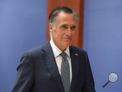 FILE - Sen. Mitt Romney, R-Utah, arrives to watch a speech by Ukrainian President Volodymyr Zelenskyy live-streamed into the U.S. Capitol, in Washington, March 16, 2022. Bipartisan Senate bargainers have agreed to a slimmed-down $10 billion package for countering COVID-19, but without any funds to help nations abroad combat the pandemic, Democrats and Republicans familiar with the talks said Monday, April 4. (AP Photo/Alex Brandon, File)