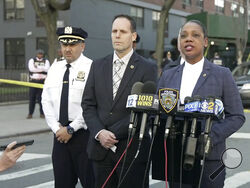 In this image taken from video provided by the NYPD, New York Police Commissioner Keechant Sewel, right, speaks during a news conference, Friday, April 8, 2022, in New York. A teenage girl has been killed and two other teens wounded in a shooting near a Bronx school. (NYPD via AP)