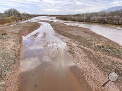 This April 10, 2022 image shows sand bars developing in the Rio Grande on the northern edge of Albuquerque, N.M. Irrigation districts from the Pacific Northwest to the Colorado River Basin already are warning farmers to expect less water this year despite growing demands fueled by ever-drying conditions. (AP Photo/Susan Montoya Bryan)