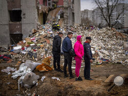 Residents look at their house destroyed by a Russian bomb in Chernihiv on Friday, April 22, 2022. (AP Photo/Emilio Morenatti)