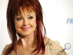 FILE - Naomi Judd poses at the Hero Dog Awards at the Beverly Hilton Hotel in Beverly Hills, Calif., Oct. 6, 2012. Judd, the Kentucky-born matriarch of the Grammy-winning duo The Judds and mother of Wynonna and Ashley Judd, has died, her family announced Saturday, April 30, 2022. She was 76. (Photo by Chris Pizzello/Invision/AP, File)