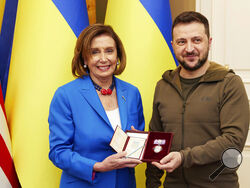 In this image released by the Ukrainian Presidential Press Office on Sunday, May 1, 2022, Ukrainian President Volodymyr Zelenskyy, right, awards the Order of Princess Olga, the third grade, to U.S. Speaker of the House Nancy Pelosi in Kyiv, Ukraine, Saturday, April 30, 2022. Pelosi, second in line to the presidency after the vice president, is the highest-ranking American leader to visit Ukraine since the start of the war, and her visit marks a major show of continuing support for the country's struggle aga
