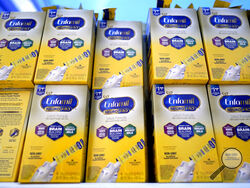 FILE - Infant formula is stacked on a table during a baby formula drive to help with the shortage May 14, 2022, in Houston. President Joe Biden has invoked the Defense Production Act to speed production of infant formula and has authorized flights to import supply from overseas. (AP Photo/David J. Phillip, File)