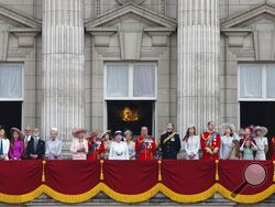 File - Britain's Queen Elizabeth II, surrounded by members of the family, stand on the balcony of Buckingham Palace to watch the fly past after the Trooping The Colour parade, in central London, Saturday, June 14, 2014. The balcony appearance is the centerpiece of almost all royal celebrations in Britain, a chance for the public to catch a glimpse of the family assembled for a grand photo to mark weddings, coronations and jubilees. (AP Photo/Lefteris Pitarakis, File)