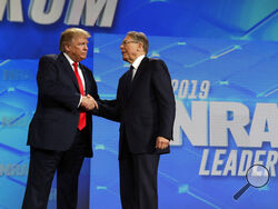 FILE - President Donald Trump shakes hands with NRA executive vice president and CEO Wayne LaPierre, has he arrives to speak to the annual meeting of the National Rifle Association, Friday, April 26, 2019, in Indianapolis. The National Rifle Association is going ahead with its annual meeting in Houston just days after the shooting massacre at a Texas elementary school that left 19 children and 2 teachers dead. With protests planned outside, former President Donald Trump and other leading GOP figures, includ