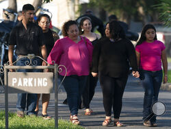 People leave a funeral home after attending a visitation for Amerie Garza, a 10-year-old victim who was killed in last week's elementary school shooting in Uvalde, Texas, Monday, May 30, 2022. (AP Photo/Jae C. Hong)