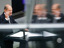 German Chancellor Olaf Scholz delivers his speech during a session of the German parliament Bundestag at the Reichstag building in Berlin, Germany, Wednesday, June 1, 2022. (AP Photo/Markus Schreiber)