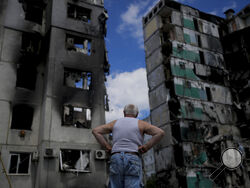 A man stands looking at a building destroyed during attacks, in Borodyanka, on the outskirts of Kyiv, Ukraine, Saturday, June 4, 2022. (AP Photo/Natacha Pisarenko)