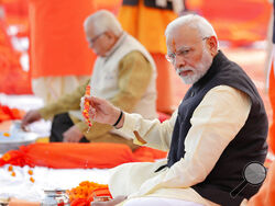 FILE- Indian Prime Minister Narendra Modi, front, performs Hindu rituals sitting at Sangam, the confluence of the Rivers Ganges and Yamuna, at Allahabad, India, Dec. 16, 2018. India is facing major diplomatic outrage from Muslim countries after top officials in the ruling Hindu nationalist party made derogatory references to Islam and the Prophet, drawing accusations of blasphemy across some Arab nations that have left New Delhi struggling to contain the damaging fallout. (AP Photo/Rajesh Kumar Singh, File)