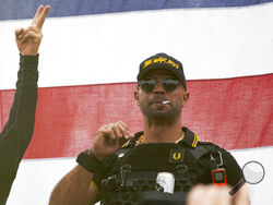 FILE - Proud Boys leader Enrique Tarrio wears a hat that says The War Boys and smokes a cigarette at a rally in Delta Park on Sept. 26, 2020, in Portland, Ore. Tarrio, the former top leader of the far-right Proud Boys extremist group, and other members were indicted Monday, June 6, 2022, on seditious conspiracy charges for what federal prosecutors say was a coordinated attack on the U.S. Capitol to stop Congress from certifying President Joe Biden's 2020 electoral victory.(AP Photo/Allison Dinner, File)