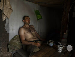 A Ukrainian serviceman takes a break after digging trenches near the frontline in Donetsk region, eastern Ukraine, Wednesday, June 8, 2022. (AP Photo/Bernat Armangue)