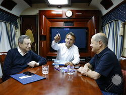 French President Emmanuel Macron, center, German Chancellor Olaf Scholz, right, and Italian Prime Minister Mario Draghi travel on board a train bound to Kyiv after departing from Poland Thursday, June 16, 2022. The Europeans leaders are expected to meet with Ukraine's President Volodymyr Zelenskyy as they prepare for a key European Union leaders' summit in Brussels next week and a June 29-30 NATO summit in Madrid.(Ludovic Marin, Pool via AP)