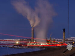 FILE - In this photo taken with a slow shutter speed, taillights trace the path of a motor vehicle at the Naughton Power Plant, Thursday, Jan. 13, 2022, in Kemmerer, Wyo. While the power plant will be closed in 2025, Bill Gates' company TerraPower announced it had chosen Kemmerer for a nontraditional, sodium-cooled nuclear reactor that will bring on workers from a local coal-fired power plant scheduled to close soon. The U.S. nuclear industry has provided a steady 20% of the nation's power for years, but no