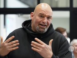 FILE - Pennsylvania Lt. Gov. John Fetterman visits with people attending a Democratic Party event for candidates to meet and collect signatures for ballot petitions for the upcoming Pennsylvania primary election, at the Steamfitters Technology Center in Harmony, Pa., March 4, 2022. The fate of the Democratic Party is intertwined in a pair of Pennsylvania elections that’ll be closely watched this year. John Fetterman could help the party keep control of the Senate. (AP Photo/Keith Srakocic, File)