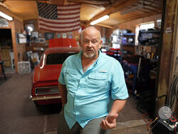 Retired Houston Fire Captain Russell Harris poses for a photograph inside his workshop at his home Wednesday, June 22, 2022, in East Bernard, Texas. (AP Photo/David J. Phillip)