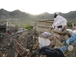 A man stands among destruction after an earthquake in Gayan village, in Paktika province, Afghanistan, Thursday, June 23, 2022. A powerful earthquake struck a rugged, mountainous region of eastern Afghanistan early Wednesday, flattening stone and mud-brick homes in the country's deadliest quake in two decades, the state-run news agency reported. (AP Photo/Ebrahim Nooroozi)