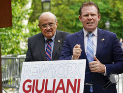 Andrew Giuliani, right, a Republican candidate for Governor of New York, is joined by his father, former New York City mayor Rudy Giuliani, during a news conference, June 7, 2022, in New York. One place the former New York City mayor is in high demand these days is on the campaign of his son, Andrew Giuliani, who on Tuesday is hoping to become the Republican nominee for governor of New York. (AP Photo/Mary Altaffer, File)