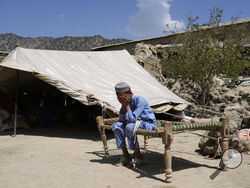 Afghan boy sits in a courtyard of her destroyed home after an earthquake in Gayan district in Paktika province, Afghanistan, Sunday, June 26, 2022. A powerful earthquake struck a rugged, mountainous region of eastern Afghanistan early Wednesday, flattening stone and mud-brick homes in the country's deadliest quake in two decades, the state-run news agency reported. (AP Photo/Ebrahim Nooroozi)