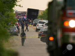 Body bags lie at the scene where a tractor trailer with multiple dead bodies was discovered, Monday, June 27, 2022, in San Antonio. (AP Photo/Eric Gay)