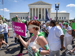 Mahayana Landowne, of Brooklyn, N.Y., wears a "Lady Justice" costume as she marches past the Supreme Court during a protest for abortion-rights, Thursday, June 30, 2022, in Washington. (AP Photo/Jacquelyn Martin)