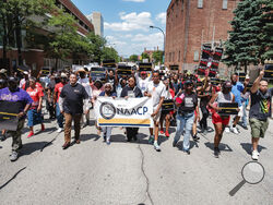 People walk in an NAACP-led march and rally for Jayland Walker, Sunday, July 3, 2022, in Akron, Ohio. Walker was unarmed when Akron police chased him on foot and killed him in a hail of bullets, but officers believed he had shot at them earlier from a vehicle and feared he was preparing to fire again, authorities said. (Andrew Dolph/Times Reporter via AP)