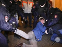 FILE - Police officers detain demonstrators in St. Petersburg, Russia, Feb. 24, 2022. When President Vladimir Putin sent troops to Ukraine, a massive wave of outrage and anti-war sentiment swept Russia. The Kremlin in response insisted that what it called a “special military operation” in Ukraine attracted overwhelming public support, and moved swiftly to suppress any dissent. (AP Photo, File)