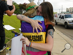 Derenda Hancock, co-director of the Jackson Women's Health Organization clinic patient escorts, better known as the Pink House defenders, left, hugs a tearful abortion rights supporter Sonnie Bane, outside the Jackson Women's Health Organization clinic in Jackson, Miss., Wednesday, July 6, 2022. The clinic is the only facility that performs abortions in the state. However, on Tuesday, a chancery judge rejected a request by the clinic to temporarily block a state law banning most abortions. Without other dev