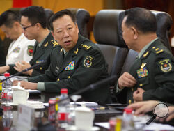 FILE - China's People's Liberation Army (PLA) Gen. Li Zuocheng, center, speaks during a meeting with U.S. Army Chief of Staff Gen. Mark Milley, not shown, at the Bayi Building in Beijing on Aug. 16, 2016. China has demanded the U.S. cease military "collusion" with Taiwan during a virtual meeting between the joint chiefs of staff from the two countries, whose relationship has grown increasingly fractious. (AP Photo/Mark Schiefelbein, Pool, File)