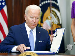 FILE - President Joe Biden signs into law S. 2938, the Bipartisan Safer Communities Act gun safety bill, in the Roosevelt Room of the White House in Washington, Saturday, June 25, 2022. (AP Photo/Pablo Martinez Monsivais, File)