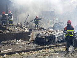 In this photo provided by the Ukrainian Emergency Service, firefighters work to extinguish fire at a building damaged by shelling, in Vinnytsia, Ukraine, Thursday, July 14, 2022. (Ukrainian Emergency Service via AP)