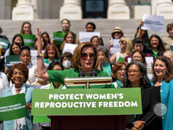 House Speaker Nancy Pelosi of Calif., accompanied by female House Democrats, speaks at an event ahead of a House vote on the Women's Health Protection Act and the Ensuring Women's Right to Reproductive Freedom Act at the Capitol in Washington, Friday, July 15, 2022. (AP Photo/Andrew Harnik)