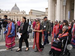 FILE - President of the Metis community, Cassidy Caron, second left, and other delegates arrive to speak to the media in St. Peter's Square after their meeting with Pope Francis at The Vatican, March 28, 2022. Pope Francis’ trip to Canada, which begins Sunday July 24, 2022, to apologize for the horrors of church-run Indigenous residential schools marks a radical rethink of the Catholic Church’s missionary legacy in the Americas, spurred on by the first American pope and the discovery of hundreds of unmarked