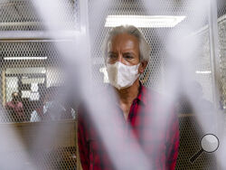 Award-winning journalist Jose Ruben Zamora, who was arrested the day before, stands inside a cell after a court hearing, in Guatemala City, Saturday. (AP Photo/Moises Castillo)