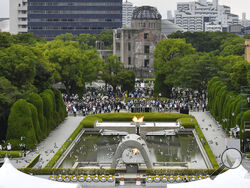 Doves fly over the cenotaph dedicated to the victims of the atomic bombing during the ceremony marking the 77th anniversary of the world's first atomic bombing, at the Hiroshima Peace Memorial Park in Hiroshima, western Japan Saturday, Aug. 6, 2022. (Kyodo News via AP)