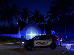 Police stand outside an entrance to former President Donald Trump's Mar-a-Lago estate, Monday, Aug. 8, 2022, in Palm Beach, Fla. Trump said in a lengthy statement that the FBI was conducting a search of his Mar-a-Lago estate and asserted that agents had broken open a safe. (AP Photo/Wilfredo Lee)