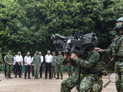 In this photo released by the Taiwan Ministry of National Defense, Taiwan's President Tsai Ing-wen watches soldiers operate equipment during a visit to a naval station on Penghu, an archipelago of several dozen islands off Taiwan's western coast on Tuesday, Aug. 30, 2022. Tsai told the self-ruled island's military units Tuesday to keep their cool in the face of daily warplane flights and warship maneuvers by rival China, saying that Taiwan will not allow Beijing to provoke a conflict.visit to the She also i