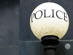 A lamp shines outside police headquarters in Greensboro, N.C., on Wednesday, June 22, 2022. The city recently let lapse its contract for Fog Reveal, a powerful cellphone-tracking tool that some advocates fear violates people's privacy rights. (AP Photo/Allen G. Breed)