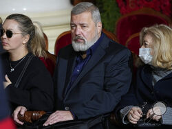 Nobel Peace Prize winner Dmitry Muratov, centre, editor-in-chief of the influential Russian newspaper Novaya Gazeta, sits next to the coffin of former Soviet President Mikhail Gorbachev inside the Pillar Hall of the House of the Unions during a farewell ceremony in Moscow, Russia, Saturday, Sept. 3, 2022. Gorbachev, who died Tuesday at the age of 91, will be buried at Moscow's Novodevichy cemetery next to his wife, Raisa, following a farewell ceremony at the Pillar Hall of the House of the Unions, an iconic