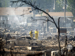 Firefighters survey homes on Wakefield Avenue destroyed by the Mill Fire on Saturday, Sept. 3, 2022, in Weed, Calif. (AP Photo/Noah Berger)