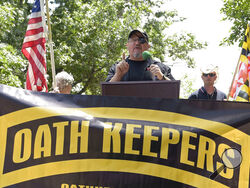 FILE - Stewart Rhodes, founder of the Oath Keepers, center, speaks during a rally outside the White House in Washington, June 25, 2017. A new report says that the names of hundreds of U.S. law enforcement officers, elected officials and military members appear on the leaked membership rolls of a far-right extremist group that's accused of playing a key role in the Jan. 6, 2021, riot at the U.S. Capitol. The Anti-Defamation League Center on Extremism pored over more than 38,000 names on leaked Oath Keepers m