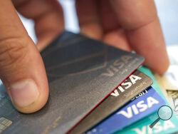 FILE - Visa credit cards are seen on Aug. 11, 2019, in New Orleans. Payment processor Visa Inc. said late Saturday, Sept. 10, 2022, that it plans to start separately categorizing sales at gun shops. (AP Photo/Jenny Kane, File)