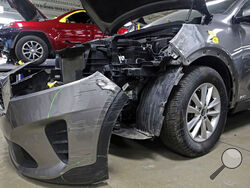 A Kia which was damaged after being stolen is seen at an auto repair shop in Milwaukee on Wednesday, Jan. 27, 2021. Some Hyundai and Kia cars and SUVs are missing a key anti-theft device, and the crooks have figured it out. An insurance industry group says they're being stolen at a rate nearly double the rest of the auto industry because they don't have computer chips in the keys. (Angela Peterson//Milwaukee Journal-Sentinel via AP)